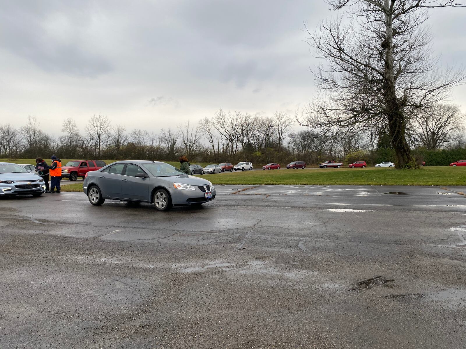 Cars lined up at St. Luke's Missionary Baptist Church on Saturday to pick up food donations. At some points, the line spilled out of the church parking lot.