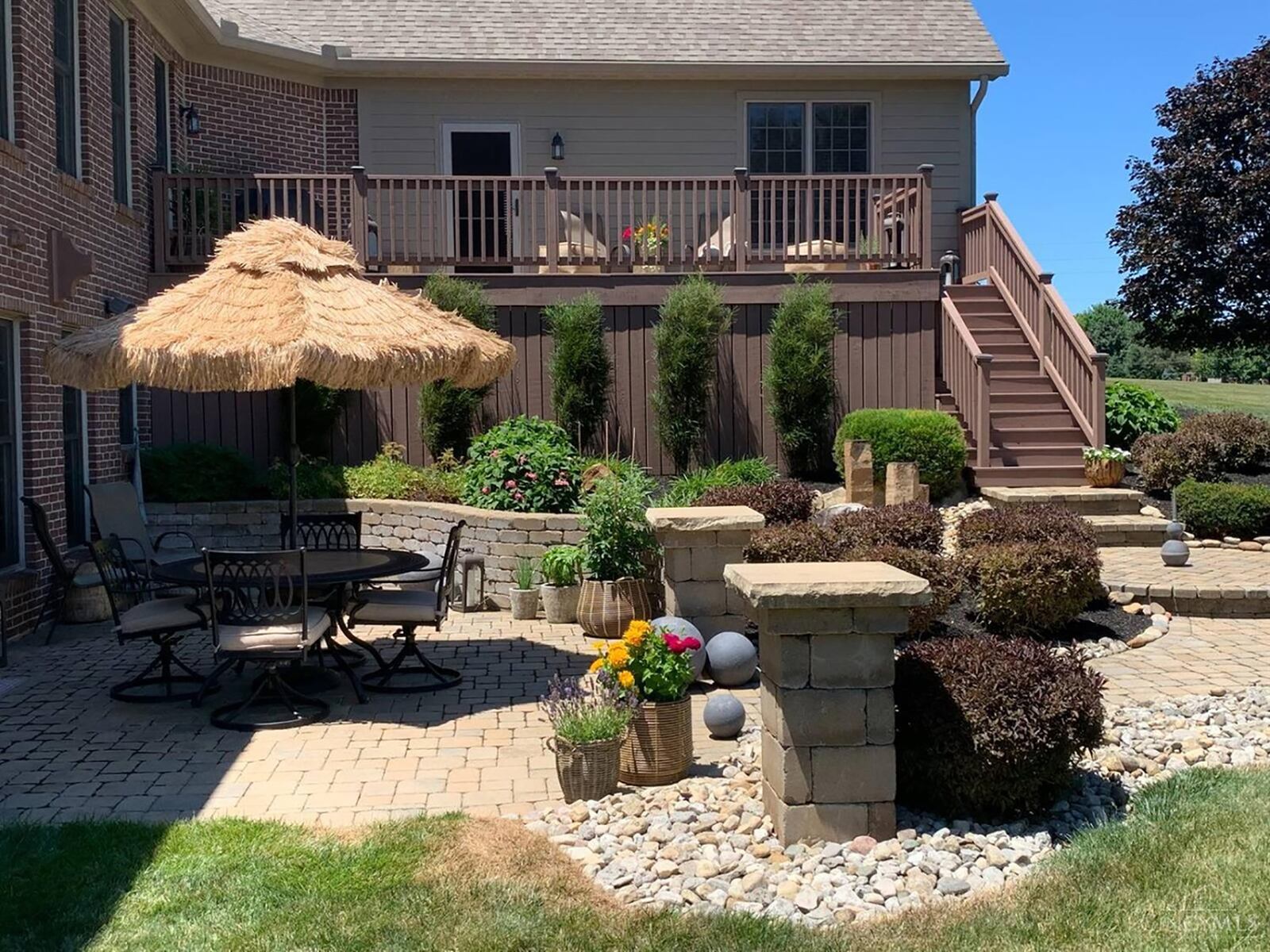 The rear of the home features a walk out basement, paver patio and wood deck off the first level with railings. The home is professionally landscaped.