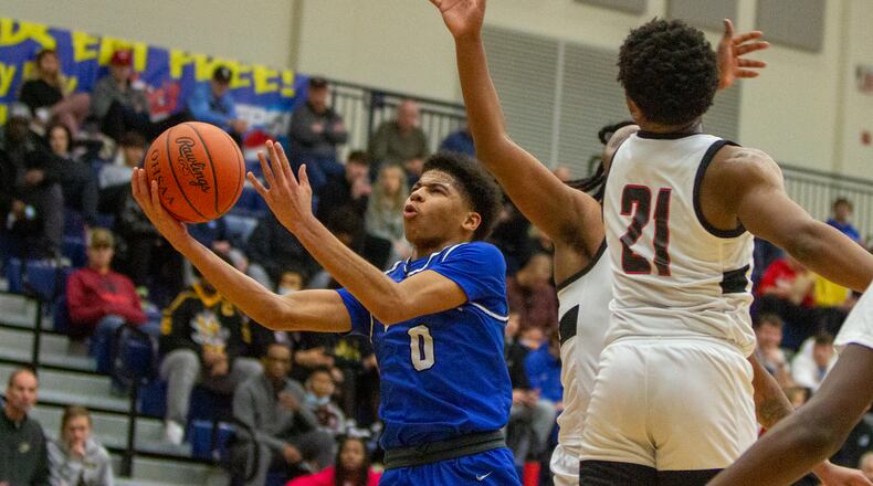 Dunbar freshman B.J. Hatcher drives to the basket Sunday against Akron Buchtel in Flyin' To The Hoop at Trent Arena. Jeff Gilbert/CONTRIBUTED