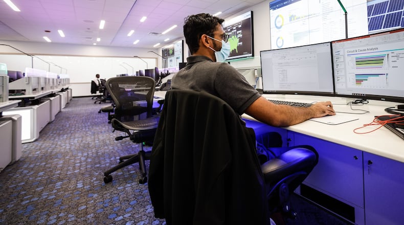 AES data scientist, Kashyap Mehta works in his new office at the newly remodeled AES smart operations center on Woodman Dr. AES spent $20 million to renovate the old Dayton Power & Light building and move AES into the future. JIM NOELKER/STAFF