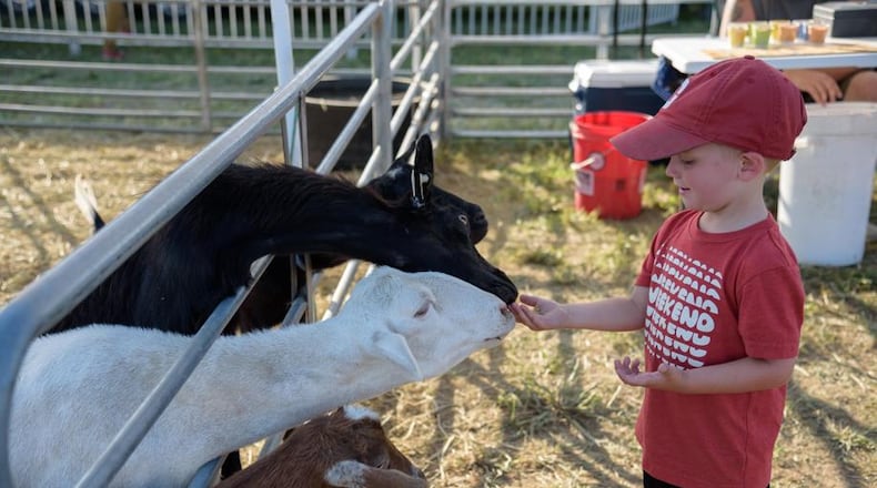 A boy feeds goats at the Montgomery County Fair in 2018, the first year the fair was at its new fairgronds home. CONTRIBUTED BY TOM GILLIAM