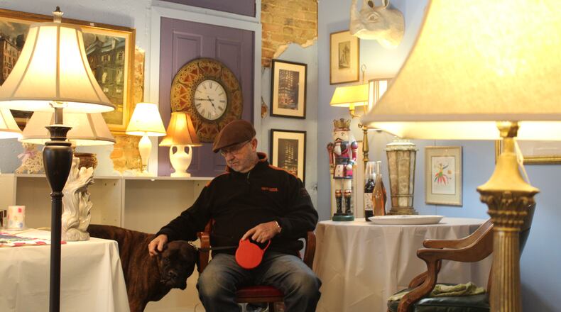 Harry Slone and his dog “Mr. Red” in his new store on East Fifth Street in St Anne’s Hill. CORNELIUS FROLIK / STAFF