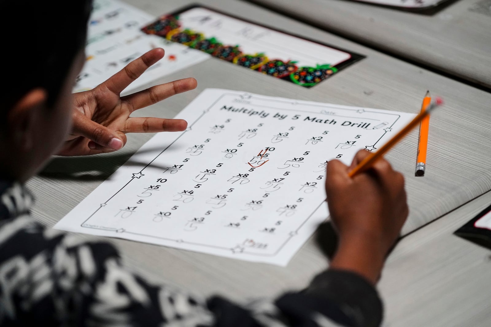 A second grader uses his hands to do math at Place Bridge Academy, May 20, 2025, in Denver. (AP Photo/Rebecca Slezak)