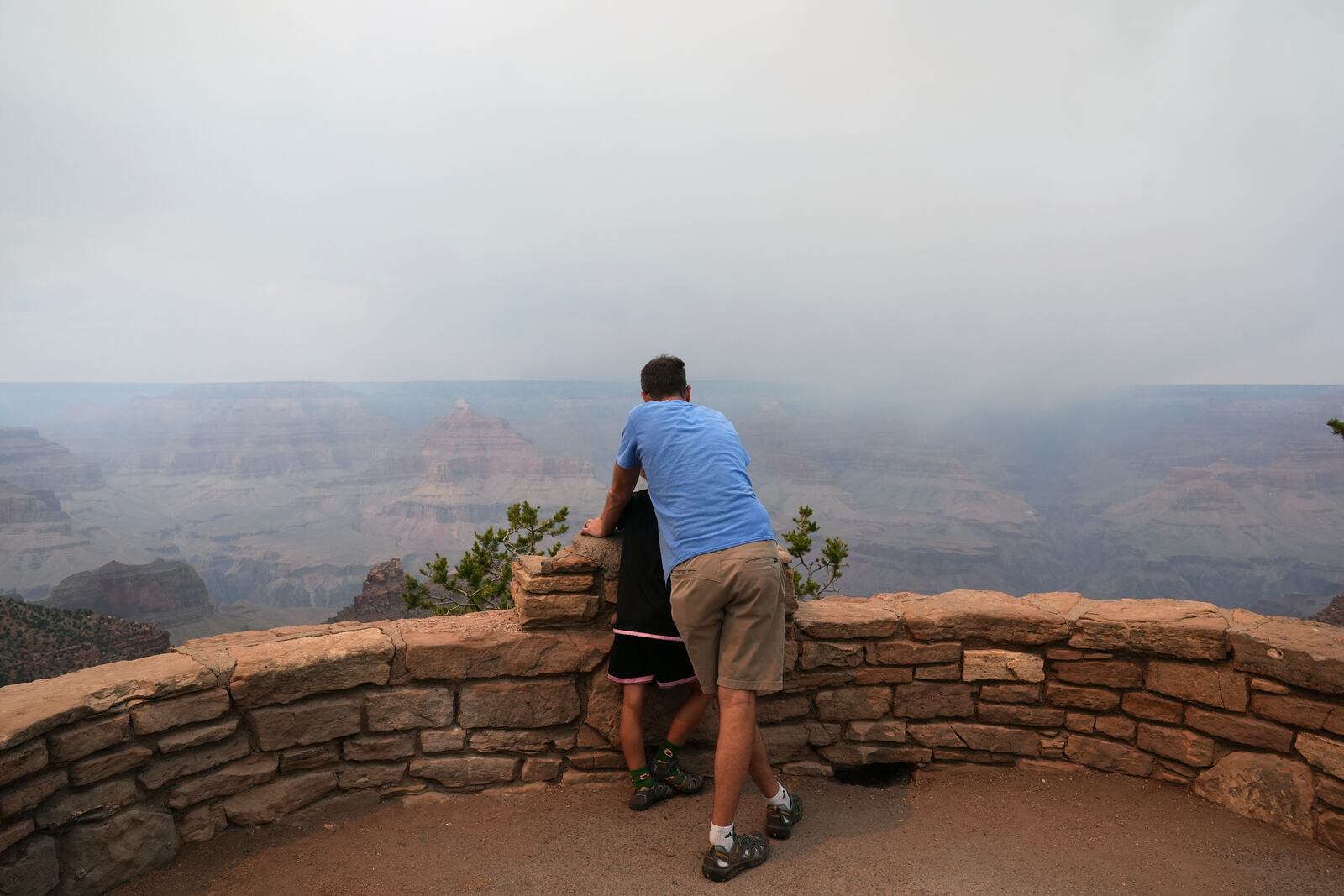 Smoke from the Dragon Bravo Fire moves over the Grand Canyon from the North Rim, Monday, July 14, 2025, in Grand Canyon National Park, Ariz. (AP Photo/Ross D. Franklin)