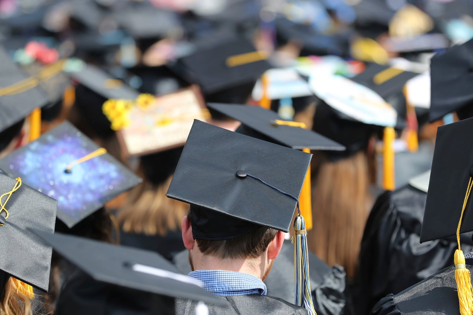 FILE - Graduates at the University of Toledo appear at commencement ceremonies in Toledo, Ohio on May 5, 2018. (AP Photo/Carlos Osorio, File)