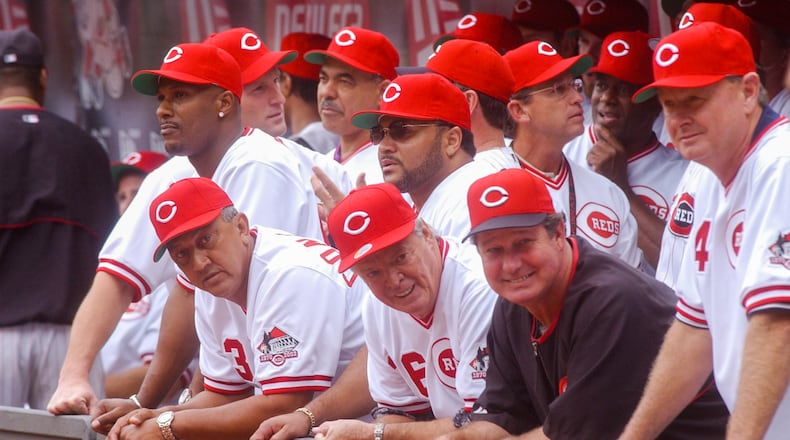 Former Reds players including Eric Davis, Dave Concepcion, Don Gullett (black shirt), and Jack Billingham and others, wait in the Reds dugout prior to post-game festivities following the final game at Cinergy Field. GREG LYNCH/STAFF