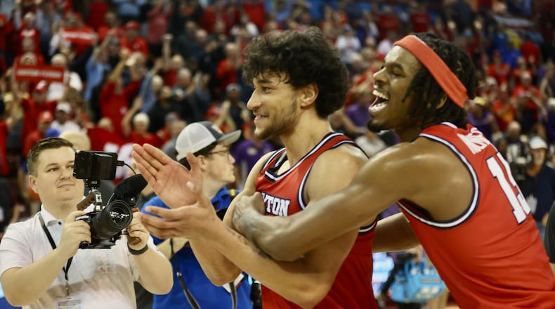 Dayton's Nate Santos and DaRon Holmes II celebrate a victory against LSU in the first round of the Charleston Classic on Thursday, Nov. 16, 2023, at TD Arena in Charleston, S.C. David Jablonski/Staff