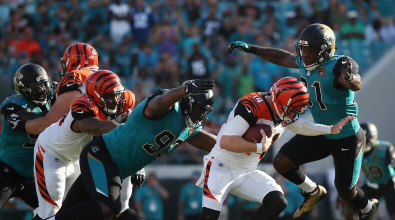 JACKSONVILLE, FL - NOVEMBER 05: Yannick Ngakoue #91 and Calais Campbell #93 of the Jacksonville Jaguars put pressure on Andy Dalton #14 of the Cincinnati Bengals in the second half of their game at EverBank Field on November 5, 2017 in Jacksonville, Florida. (Photo by Logan Bowles/Getty Images)