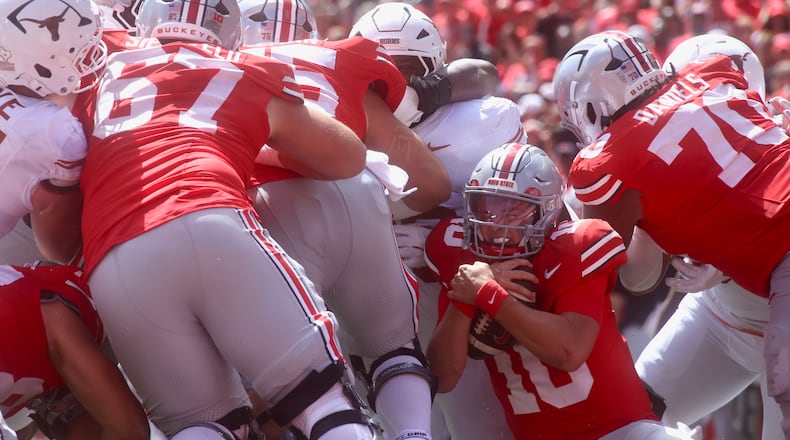 Ohio State's Julian Sayin runs the ball from near the goal line against Texas on Saturday, Aug. 30, 2025, at Ohio Stadium in Columbus. David Jablonski/Staff