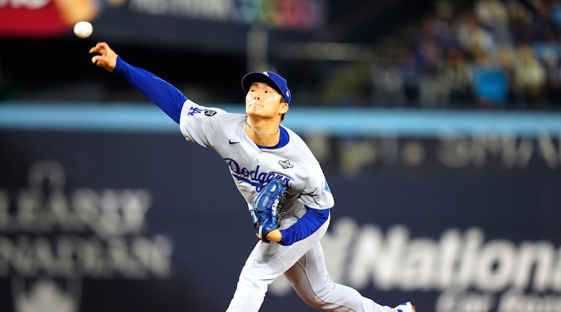 Los Angeles Dodgers pitcher Yoshinobu Yamamoto (18) delivers against the Toronto Blue Jays during the first inning in Game 2 of baseball's World Series, Saturday, Oct. 25, 2025, in Toronto. (Frank Gunn/The Canadian Press via AP)