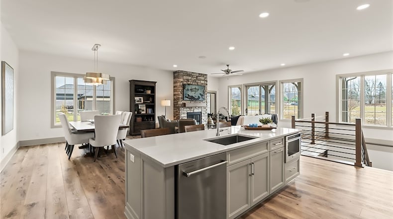 The open concept kitchen, dining room and great room has LVP flooring throughout, recessed lighting, a ceiling fan and a decorative chandelier in the dining room. A sliding glass door opens from the great room to the back patio. CONTRIBUTED