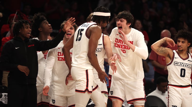 Dayton's DaRon Holmes II celebrates with teammates after a basket and a foul against Duquesne in the Atlantic 10 Conference tournament quarterfinals on Thursday, March 14, 2024, at the Barclays Center in Brooklyn, N.Y. David Jablonski/Staff