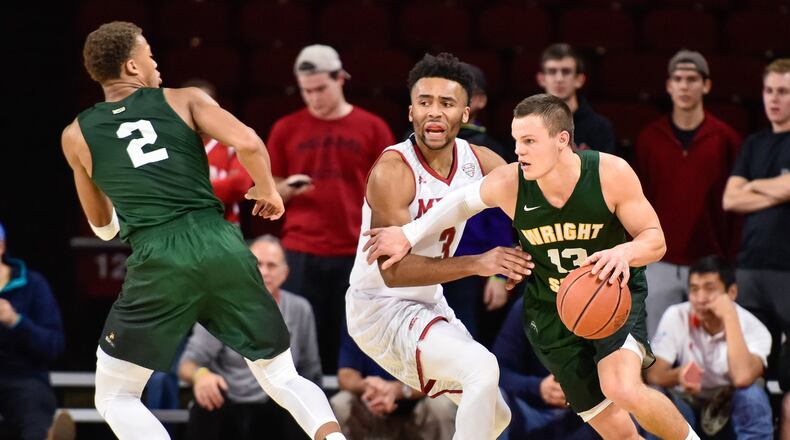 Wright State’s Grant Benzinger dribbles around Miami’s Jalen Adaway during their game Tuesday, Nov. 14 at Millett Hall on the Miami University Campus in Oxford. NICK GRAHAM/STAFF