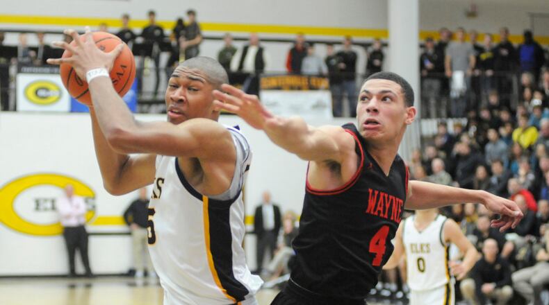 Wayne, including Brian Hill (right), had no answer for Centerville 6-9 center Mo Njie (with ball), who scored 16 points. Centerville defeated visiting Wayne 69-44 in a boys high school basketball game on Friday, Feb. 15, 2019. MARC PENDLETON / STAFF