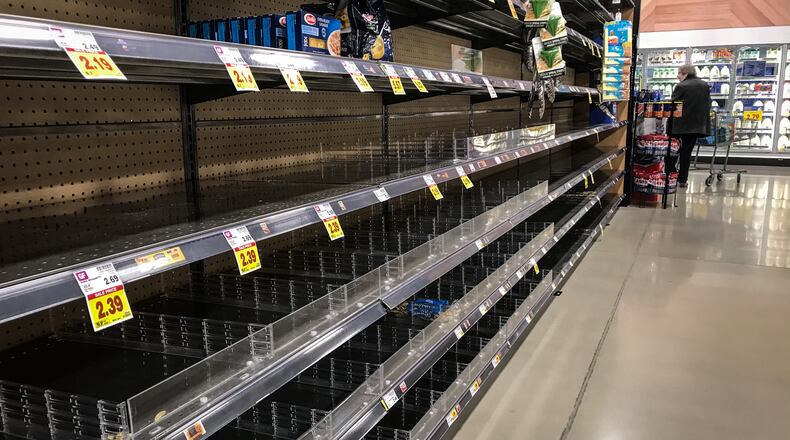 The new Kroger's Marketplace on Alex Bell was busy Monday, but there seem to be less panic buying. These pasta shelves were empty. JIM NOELKER/STAFF