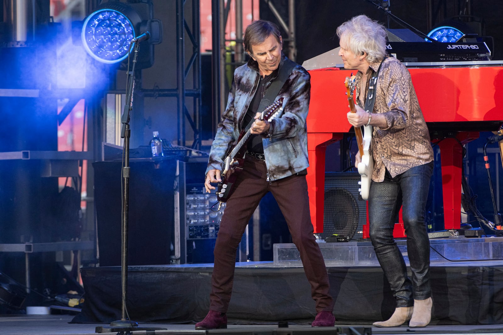 Journey guitarists Jonathan Cain, left, and Todd Jensen, right, perform at the Cleveland Browns NFL football draft party in Cleveland, Thursday, April 24, 2025. (AP Photo/Phil Long)