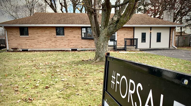 A home for sale on Bellefontaine Road in Huber Heights Wednesday, Nov. 22, 2023. The amount of homes sold each month continues to trend down through October compared to year-to-date numbers through October 2022, while the average home sale price continues to rise. MARSHALL GORBY/STAFF