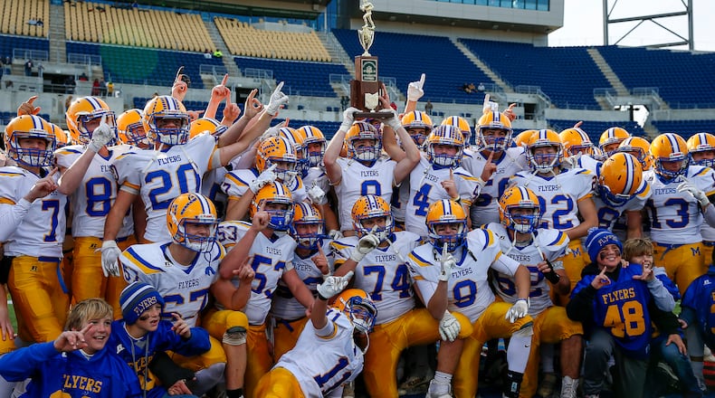 Cutline: The Marion Local High School football team hoists the trophy after beating Newark Catholic 42-7 in the Division VII state championship game on Saturday morning at Tom Benson Hall of Fame Stadium in Canton. Michael Cooper/CONTRIBUTED
