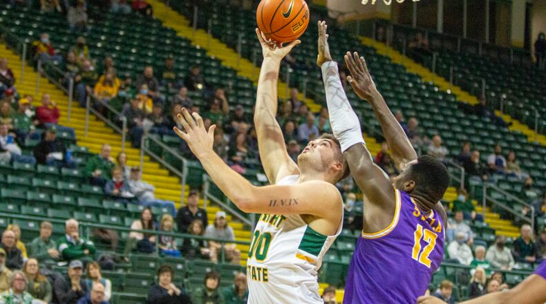 Wright State's Grant Basile puts up a shot against Tennessee Tech's Amadou Sylla during the first half Saturday at the Nutter Center. Jeff Gilbert/CONTRIBUTED