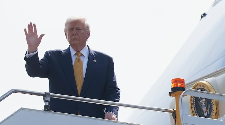 President Donald Trump waves as he boards Air Force One at Kuala Lumpur International Airport in Sepang, Malaysia, as he departs for Japan, Monday, Oct. 27, 2025. (AP Photo/Mark Schiefelbein)