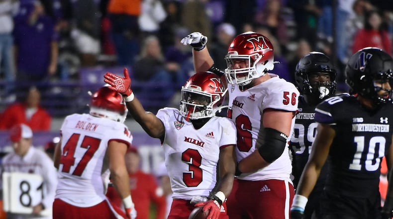 Miami (Ohio) running back Keyon Mozee (3) and offensive lineman Reid Holskey (56) signal during the second half of the team's NCAA college football game against Northwestern, Saturday, Sept. 24, 2022, in Evanston, Ill. (AP Photo/Matt Marton)