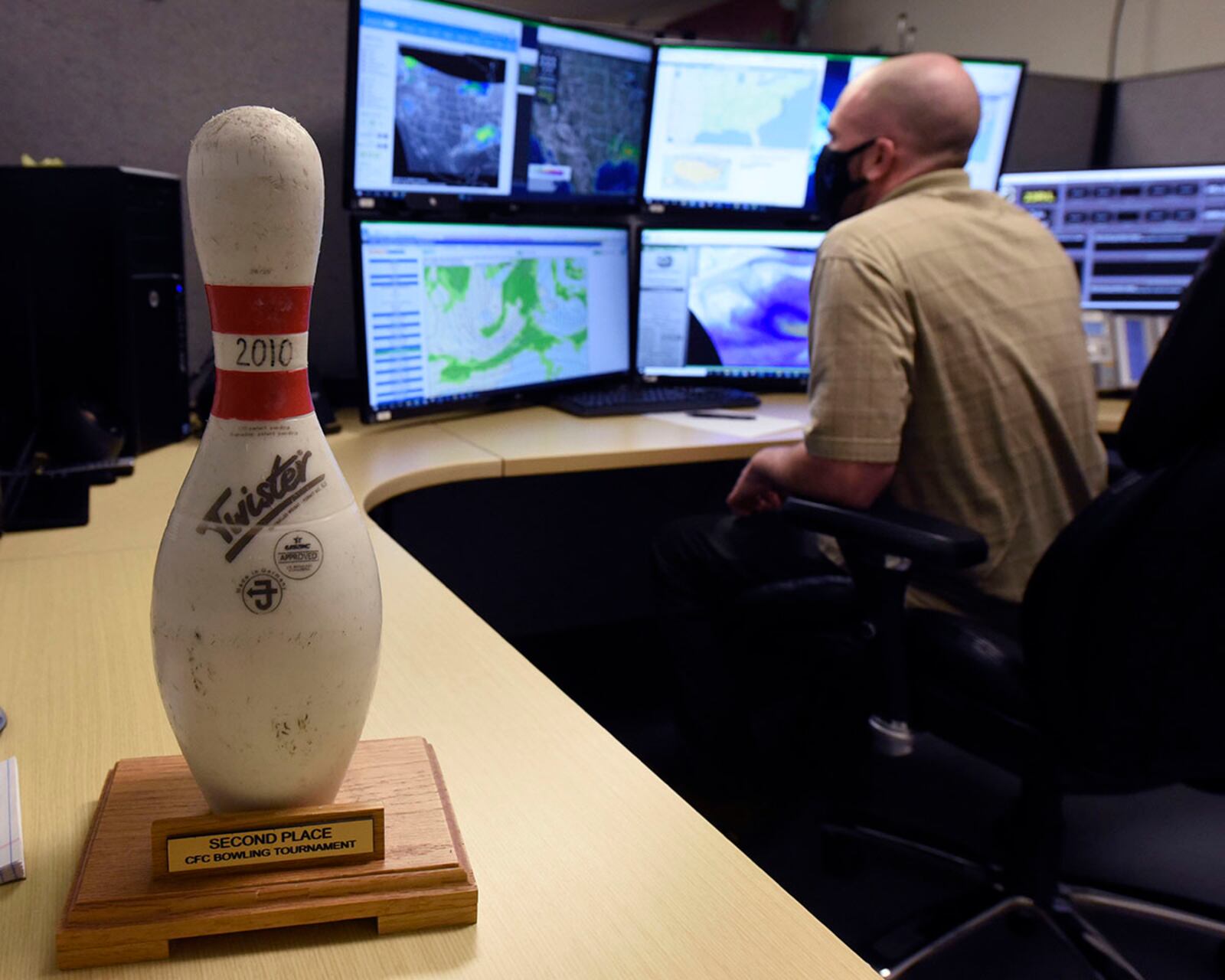 Air Force contractor Zach Grandin, an 88th Operations Support Squadron weather technician, studies forecasting models inside the Wright-Patterson Air Force Base weather station. Grandin captured the team’s bowling pin trophy in March for the most consistent, accurate forecasts. U.S. AIR FORCE PHOTO/TY GREENLEES