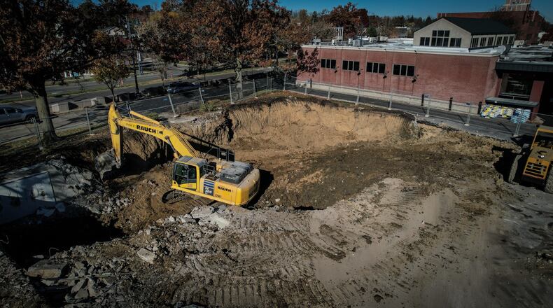 Workers move earth at the former site of PNC Bank at 2720 Far Hills Avenue just south of Dorothy Lane Market  in Oakwood Tuesday. Dorothy Lane Market bought the property in August for $1.1 million, Montgomery County land records show. Demolition of the bank started last week. JIM NOELKER/STAFF