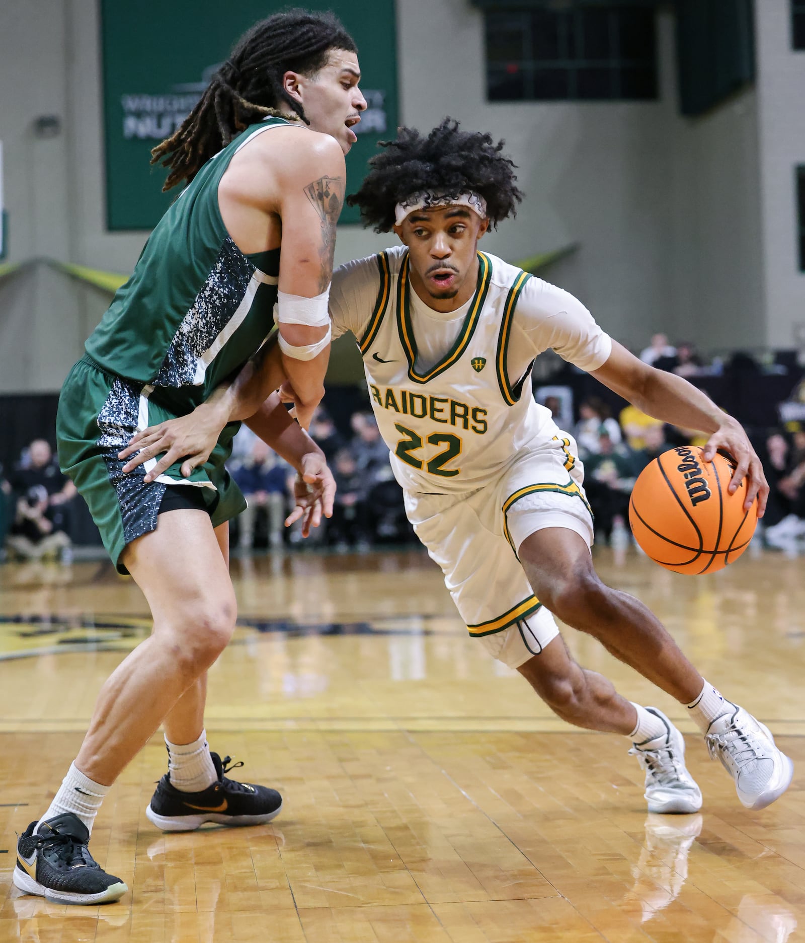 Wright State sophomore guard TJ Burch dribbles with pressure from Cleveland State's Priest Ryan during a Horizon League Championship first-round game on Wednesday, March 4 at Ervin J. Nutter Center in Fairborn. Burch scored 16 points and had five rebounds and three assists. BRYANT BILLING / STAFF