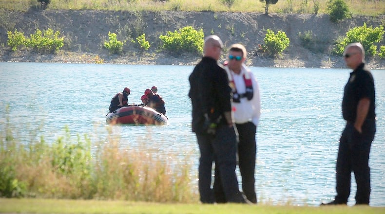 Rescue crews from Dayton, Piqua and Wright Patterson Air Force Base search a lake near Action Sports Monday, July 1, 2024 in Dayton. A swimmer was seen struggling in the water Sunday evening. MARSHALL GORBY\STAFF