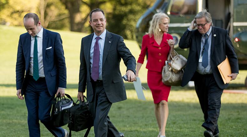 From left, President Donald Trump's White House Senior Adviser Stephen Miller, President Donald Trump's Chief of Staff Reince Priebus, Counselor to the President Kellyanne Conway, and President Donald Trump's White House Senior Adviser Steve Bannon, walk across the South Lawn after President Donald Trump arrives at the White House in Washington, Tuesday, April 18, 2017, after a short trip from Andrews Air Force Base, Md., after speaking at Snap-On Tools in Kenosha, Wis.