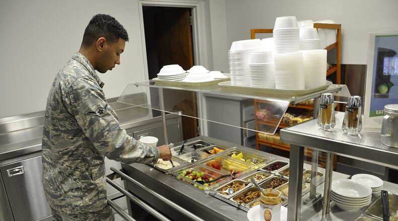 Airman Chris Savinon, Phase 2 tech school student, explores the healthier choices on the new breakfast bar at the Pitsenbarger Dining Facility. The breakfast bar is part of the Go for Green 2.0 upgrade. (U.S. Air Force photo/Mark C. Lyle)
