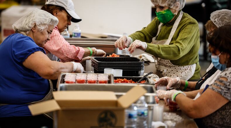 Workers at the Annunciation Greek Orthodox Church prep food for a COVID-19 version of the Dayton Greek Festival Friday Sept. 10, 2021. This year the festival is called the Greek Fest Express. Food can be ordered on line and pick-up drive thru style at the church. JIM NOELKER/STAFF