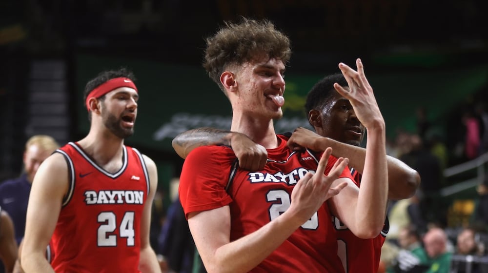 Dayton's Amaël L'Etang celebrates a victory against George Mason on Wednesday, Feb. 18, 2026, at EagleBank Arena in Fairfax, Va. David Jablonski/Staff