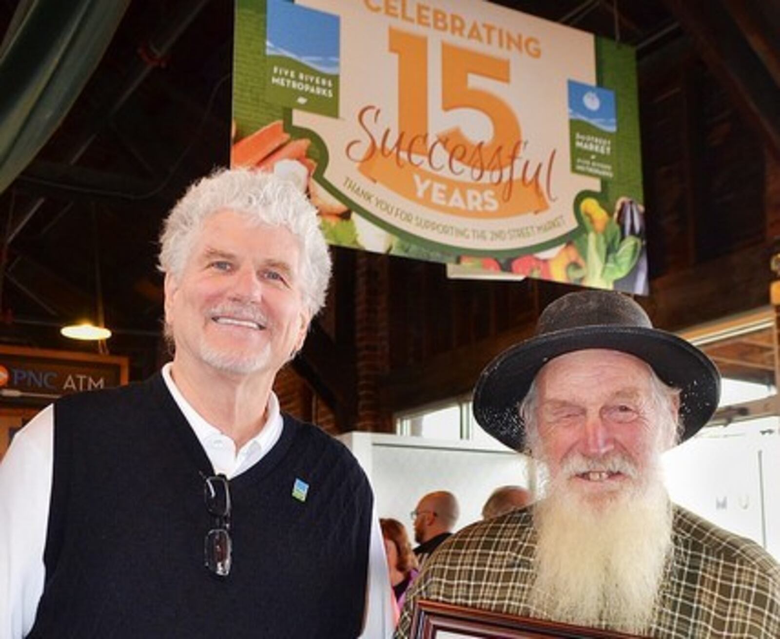 Jimmy Harless, left, with 2nd Street Market vendor Russell Garber. Harless, who has managed the market for 16 years, will retire on Dec. 31, 2018. CONTRIBUTED