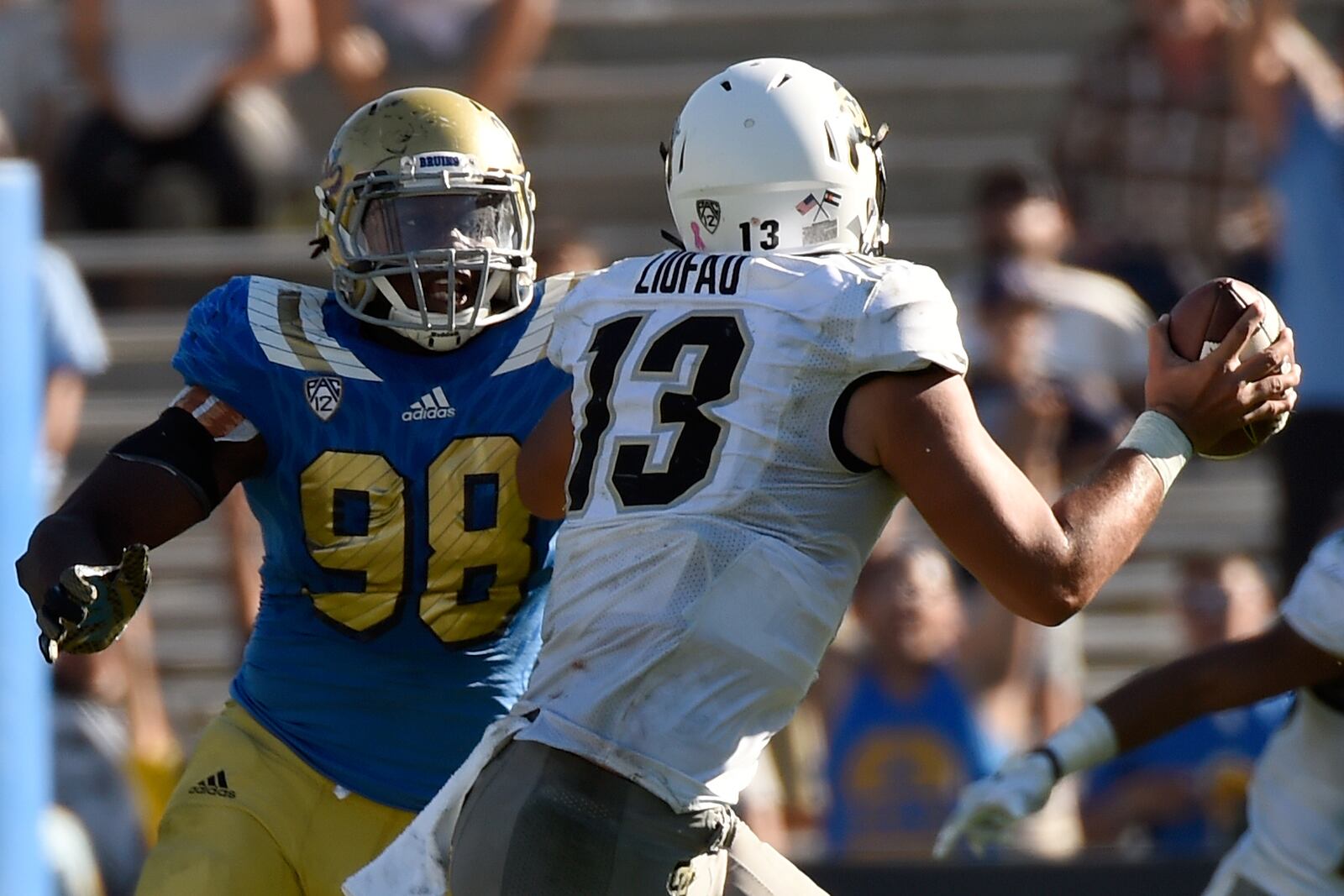 PASADENA, CA - OCTOBER 31: (Left) Takkarist McKinley #98 of the UCLA Bruins plays defense against quarterback Serfo Liufau #13 the Colorado Buffaloes in the fourth quarter at Rose Bowl on October 31, 2015 in Pasadena, California. (Photo by Lisa Blumenfeld/Getty Images)