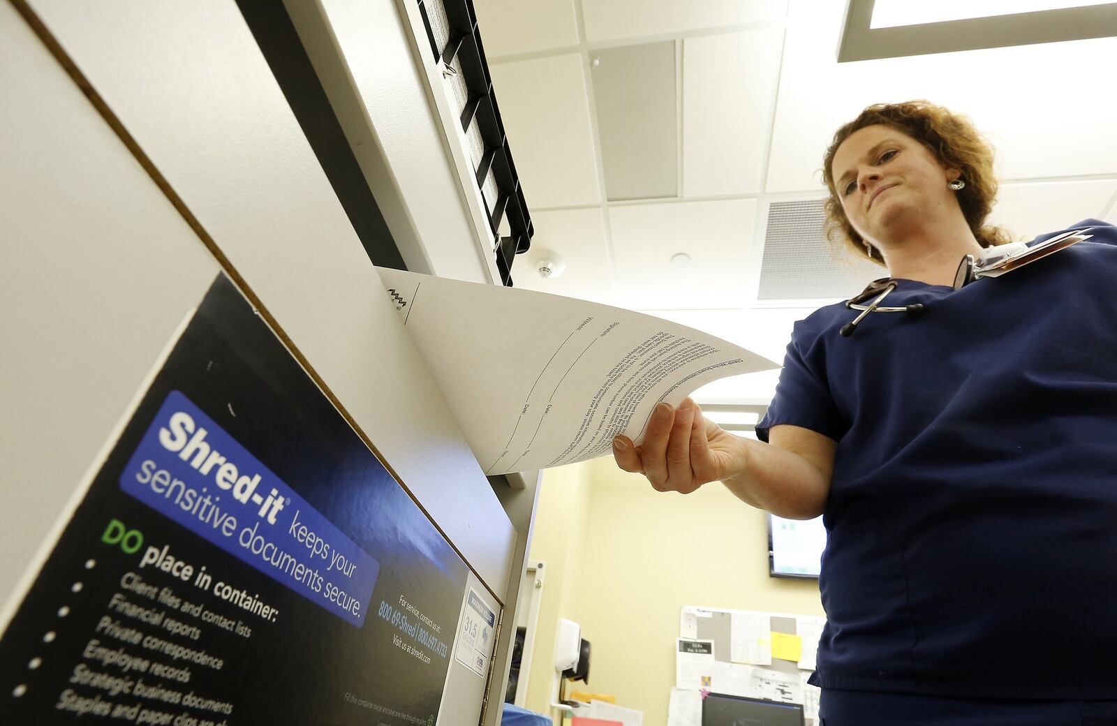 Jillian Purtee, a RN at Springfield Regional Medical Center, puts a document in the Shred-it bin at the nurses station Wednesday. Springfield Regional Medical Center’s records policies include the use of Shred-It boxes that keep discarded paperwork containing private health information in secure bins on each floor until the records can be disposed of properly.The hospital says it has made numerous improvements to its privacy standards since the breach in November including retraining staff and cutting down on the amount of paper records it stores once the information has been scanned into the computer. Bill Lackey/Staff