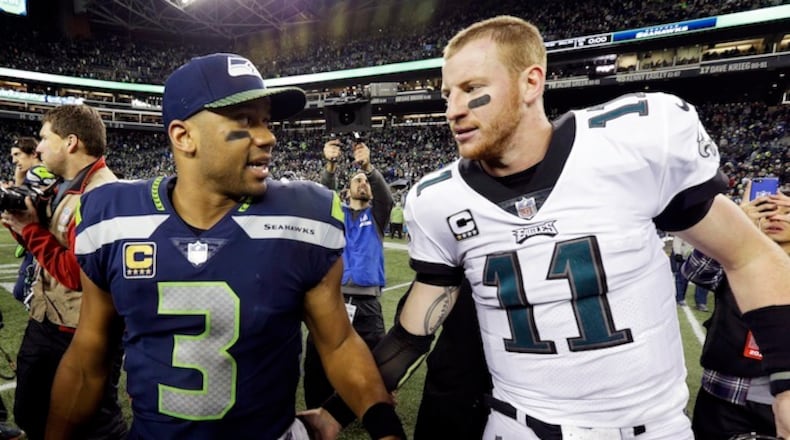 Seattle Seahawks quarterback Russell Wilson (3) talks with Philadelphia Eagles quarterback Carson Wentz after an NFL football game, Sunday, Dec. 3, 2017, in Seattle. The Seahawks won 24-10. (AP Photo/Ted S. Warren)