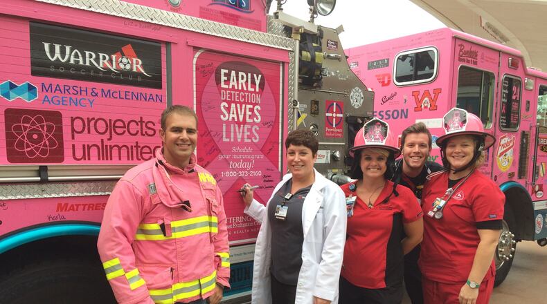 ER physician Dr. Carrie Baker (center) signs the Huber Heights pink fire truck that recently visited Sycamore Medical Center in Miamisburg in support of Breast Cancer Awareness Month and the Pink Ribbon Girls. She’s joined by Chris Warrick of the Huber Heights Fire Department; Michelle Smithson, registered nurse; Todd Geglein, registered nurse; and Kendra Johnson, registered nurse, of Sycamore Medical Center’s Emergency Department. CONTRIBUTED