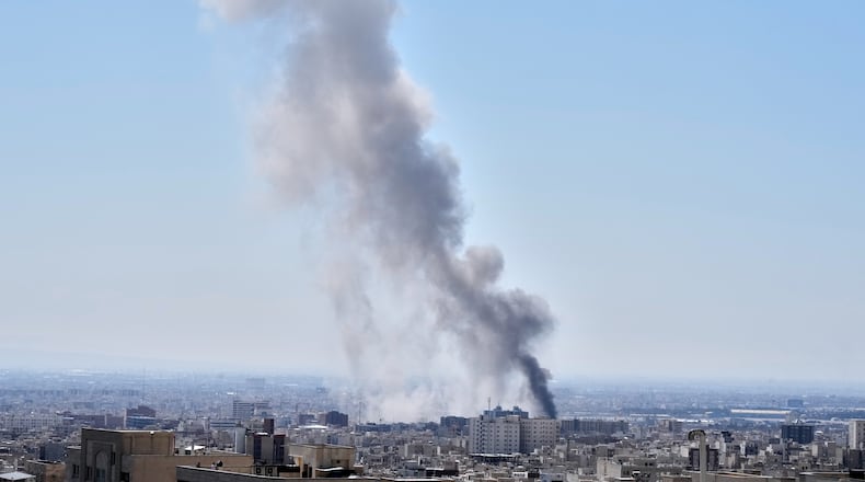A plume of smoke rises after a strike in Tehran, Iran, Sunday, March 1, 2026. (AP Photo/Vahid Salemi)