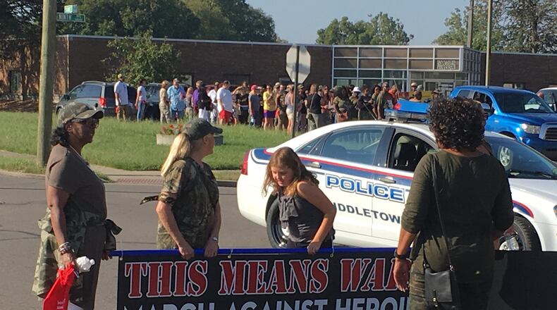 About 75 people, many wearing fatigues, marched down Yankee Road in Midddletown on Saturday as part of “500 Women Against Heroin.”
