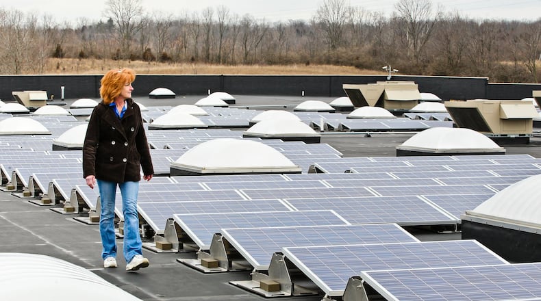 Walmart assistant manager Vicki Meredith walks past solar power arrays installed atop the Franklin location. NICK DAGGY / STAFF