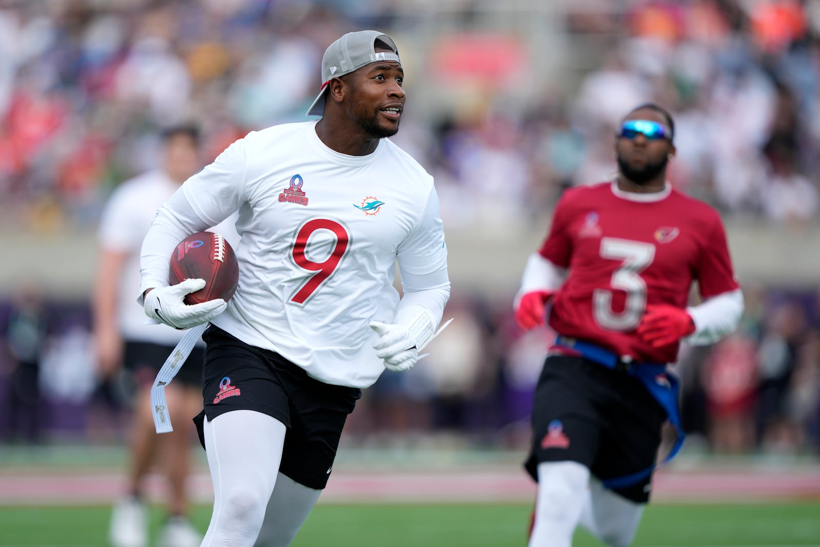 FILE - AFC tight end Jonnu Smith (9), of the Miami Dolphins, carries the ball against the NFC during the flag football event at the NFL Pro Bowl Games on Sunday, Feb. 2, 2025, in Orlando, Fla. (Doug Benc/AP Images for NFL, file)