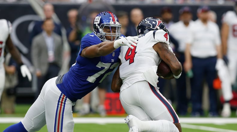 HOUSTON, TX - SEPTEMBER 23: Deshaun Watson #4 of the Houston Texans is pressured by Kerry Wynn #72 of the New York Giants in the second quarter at NRG Stadium on September 23, 2018 in Houston, Texas. (Photo by Tim Warner/Getty Images)