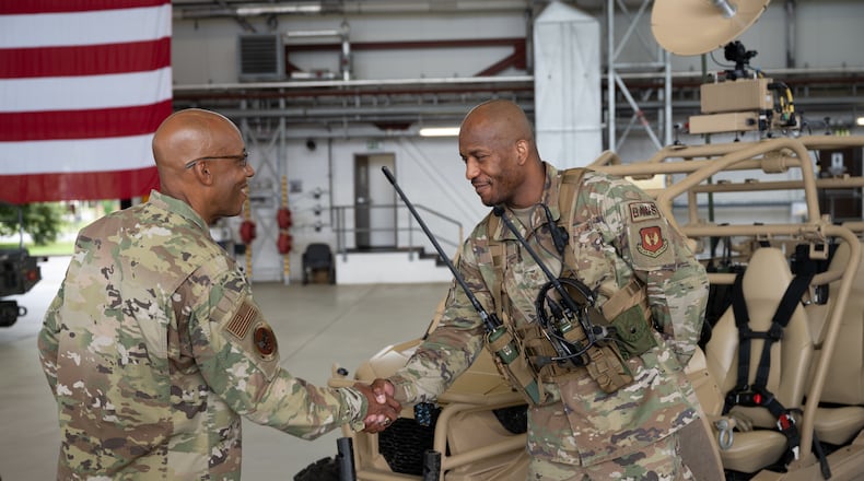 Air Force Chief of Staff Gen. CQ Brown, Jr., talks with Staff Sgt. Sean Scott, 1st Combat Communications Squadron landing zone safety officer, at a capabilities display during his visit to Ramstein Air Base, Germany, July 15, 2021. Brown took the time to meet with Airmen and get a first-hand look at Ramstein AB’s unique capabilities after delivering a message of collective defense and airpower to allies and partners at the inaugural Chief of the Air Staff’s Global Air Chiefs’ Conference. U.S. Air Force photo by Senior Airman John R. Wright