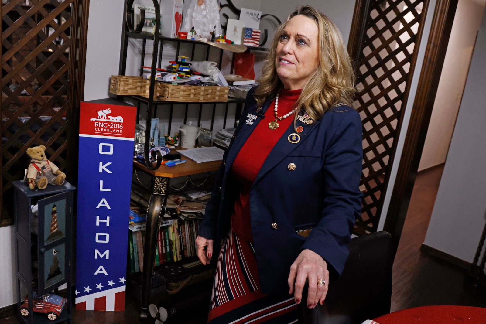 FILE - Pam Pollard stands next to a sign from the 2016 Republic National Convention, May 4, 2024, at her home in Midwest City, Okla. (AP Photo/Nate Billings, File)