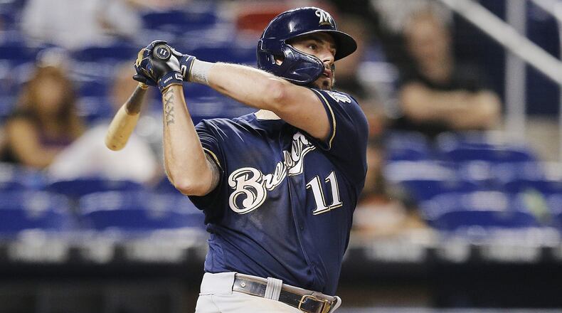 MIAMI, FLORIDA - SEPTEMBER 11: Mike Moustakas #11 of the Milwaukee Brewers hits a go-ahead two-run home run in the ninth inning against the Miami Marlins at Marlins Park on September 11, 2019 in Miami, Florida. (Photo by Michael Reaves/Getty Images)