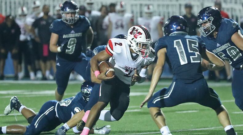 Wayne's Bryan Kinley tries to avoid a tackle by Fairmont's Grayson Holbrook and Aidan Stringer. BILL LACKEY/STAFF
