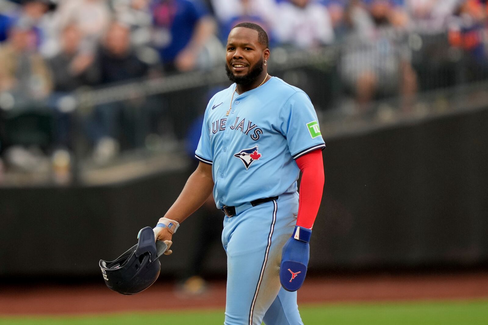Toronto Blue Jays' Vladimir Guerrero Jr. (27) smiles after being tagged at second base by New York Mets shortstop Francisco Lindor (12) during the eighth inning of a baseball game, Friday, April 4, 2025, in New York. (AP Photo/Julia Demaree Nikhinson)