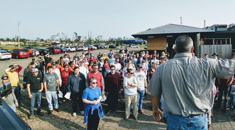 Harrison Twp. Services Director Merle Cyphers directs volunteers in a parking lot in Northridge before debris cleanup on June 1. CONTRIBUTED.