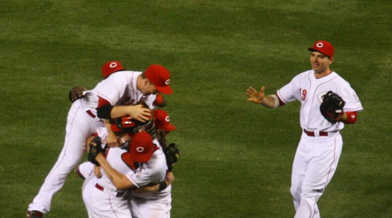 The Reds pile on Homer Bailey after the final out of his no-hitter against the Giants on Tuesday, July 2, 2013, at Great American Ball Park in Cincinnati. David Jablonski/Staff
